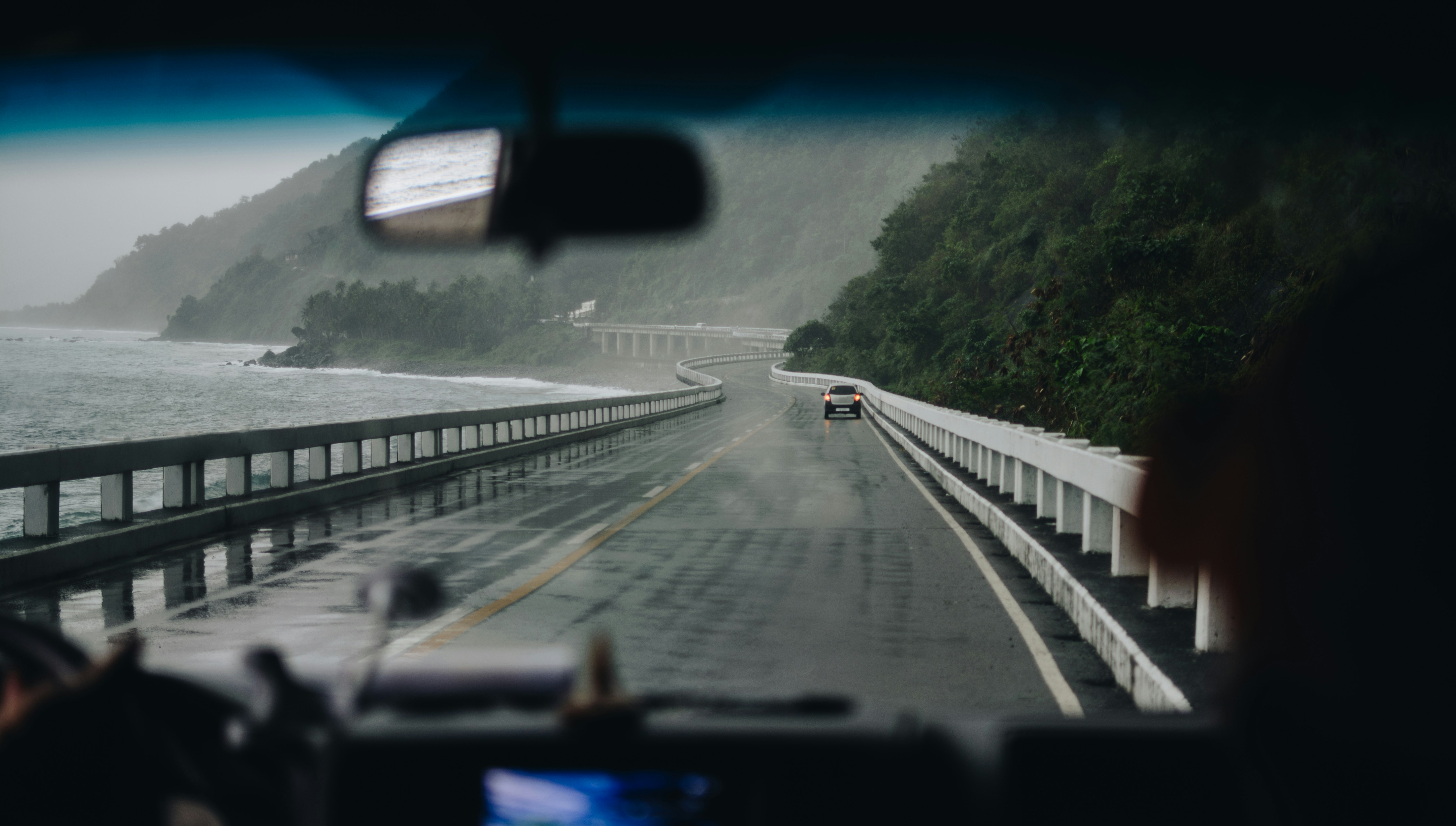 car on black and white concrete bridge